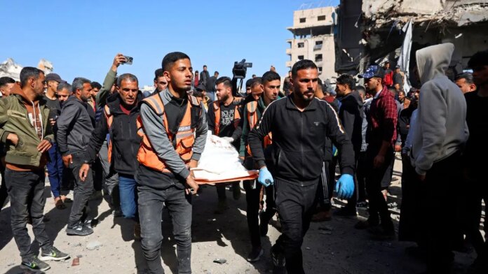 1769872205_gaza-police-station-airstrike-body-carried.jpg